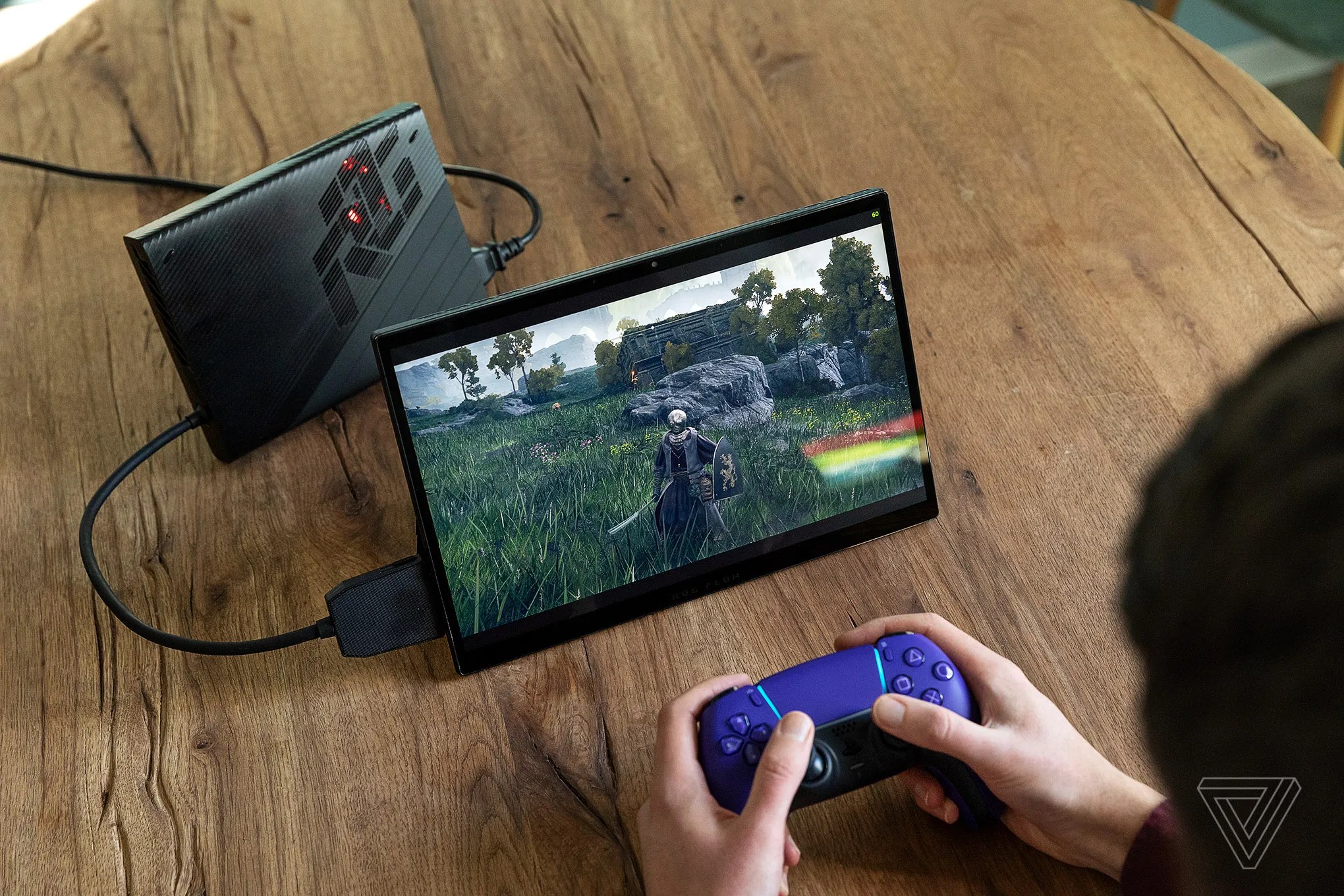 The Asus XG Mobile plugged into the Flow Z13 gaming tablet. The XG Mobile can plug into the white ROG Ally (but not the Ally X) the same way to boost its graphical capabilities.